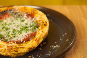 Kuvassa on tummalla lautasella tomaatti tarti tatinia